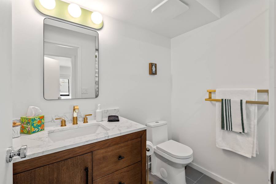Mangrove Manor: Full bathroom with wood vanity, marble top and walk in shower
