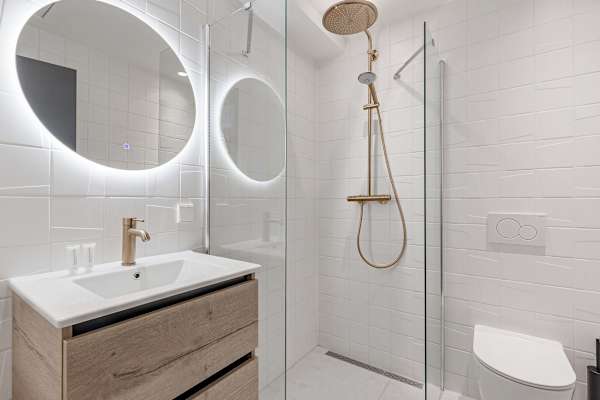 Modern bathroom with walk-in waterfall shower in Amsterdam studio apartment