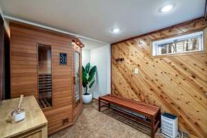 Relax and rejuvenate in this private sauna, featuring warm natural wood accents and a calming atmosphere—your perfect retreat to unwind!