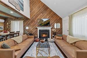 A warm welcome awaits! Settle into the couch, enjoy your favorite show on the TV, and unwind by the glowing fireplace—the perfect spot to relax.