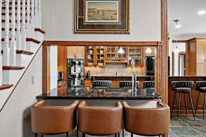 Pull up a stool at the kitchen peninsula, pour yourself a drink, and stay part of the conversation while dinner comes together just a few steps away.