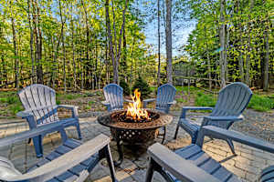 Gather around the outdoor wood-burning fire pit, surrounded by nature. A great spot for an evening of warmth, laughter, and making memories with friends or family.