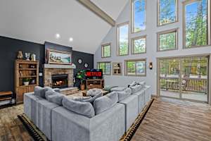 Catch up on your favorite shows on the large sectional sofa with natural light filtering in.