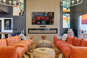Claim your corner of the sofa, light the fireplace, and let the group settle in — this is the living room everyone drifts back to.
