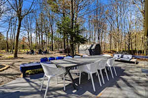 Take breakfast out on the deck — eight seats at the table, the hot tub waiting behind you, the fire pit ready for later.