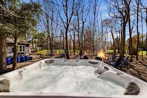 Sink into the hot tub while the fire pit crackles a few steps away and the fairway disappears into the trees — your last stop every night.