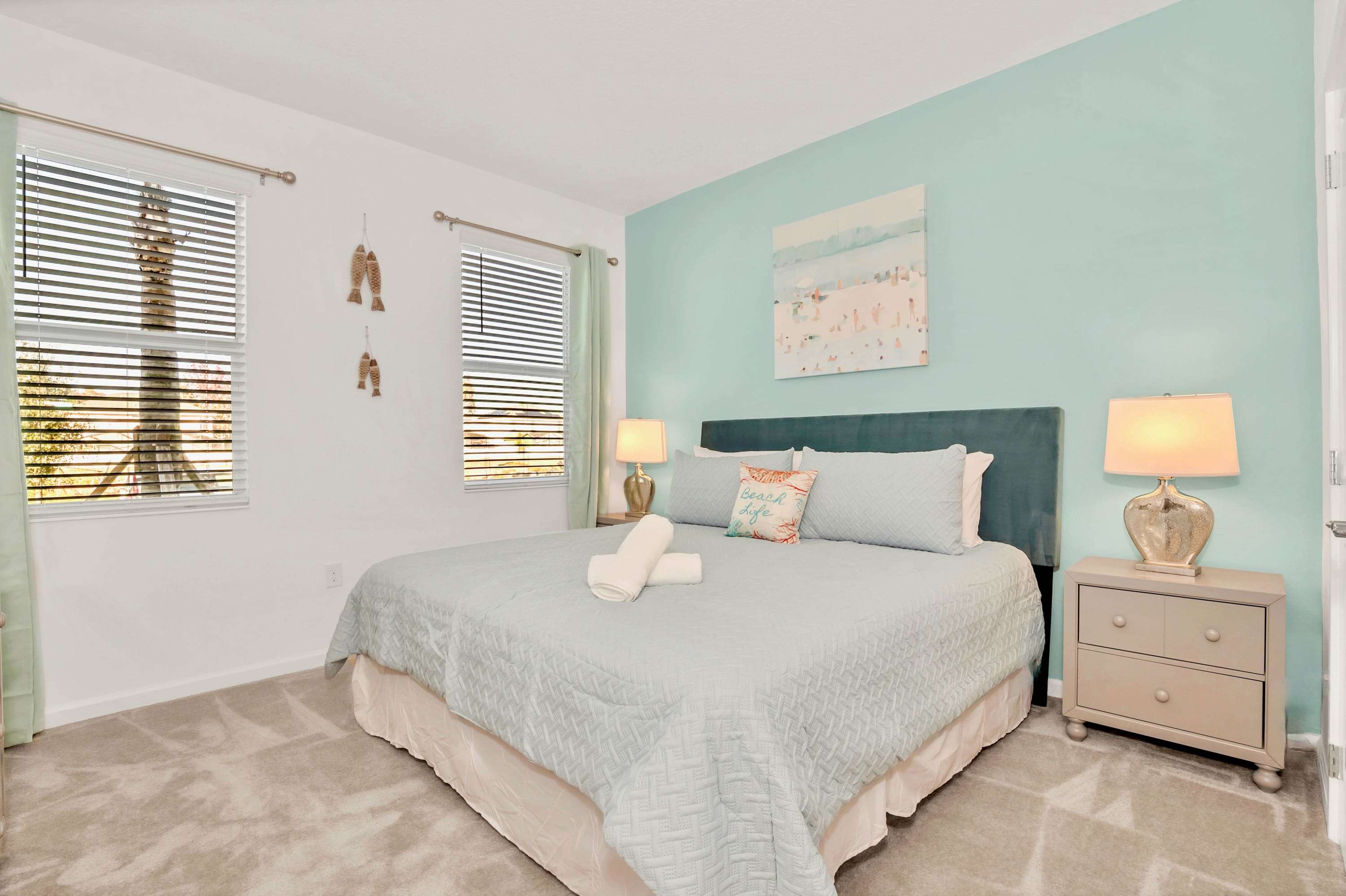 Restful guest room featuring a plush mattress and warm bedside lighting