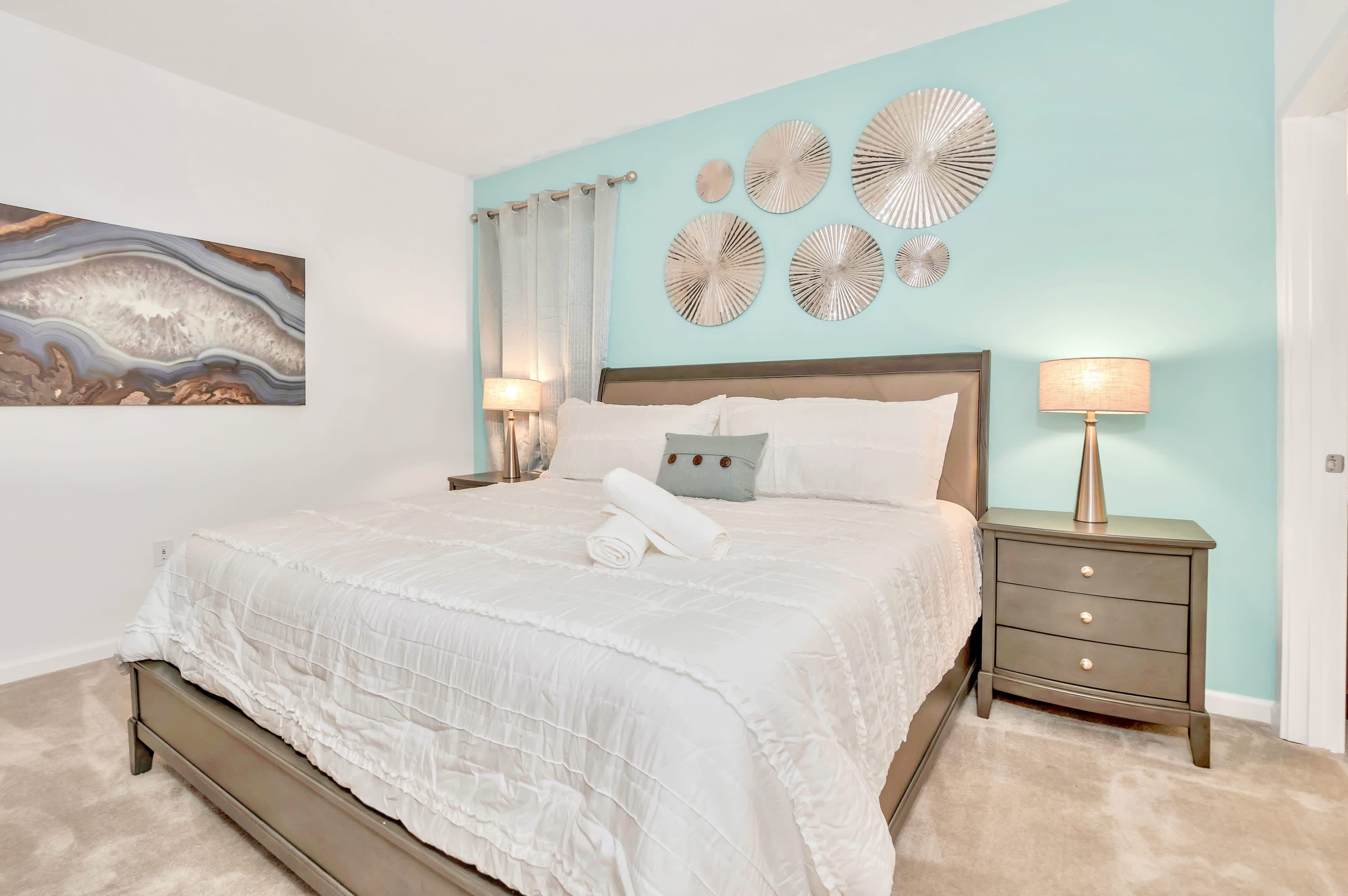 Inviting bedroom setup featuring comfortable bedding and natural sunlight