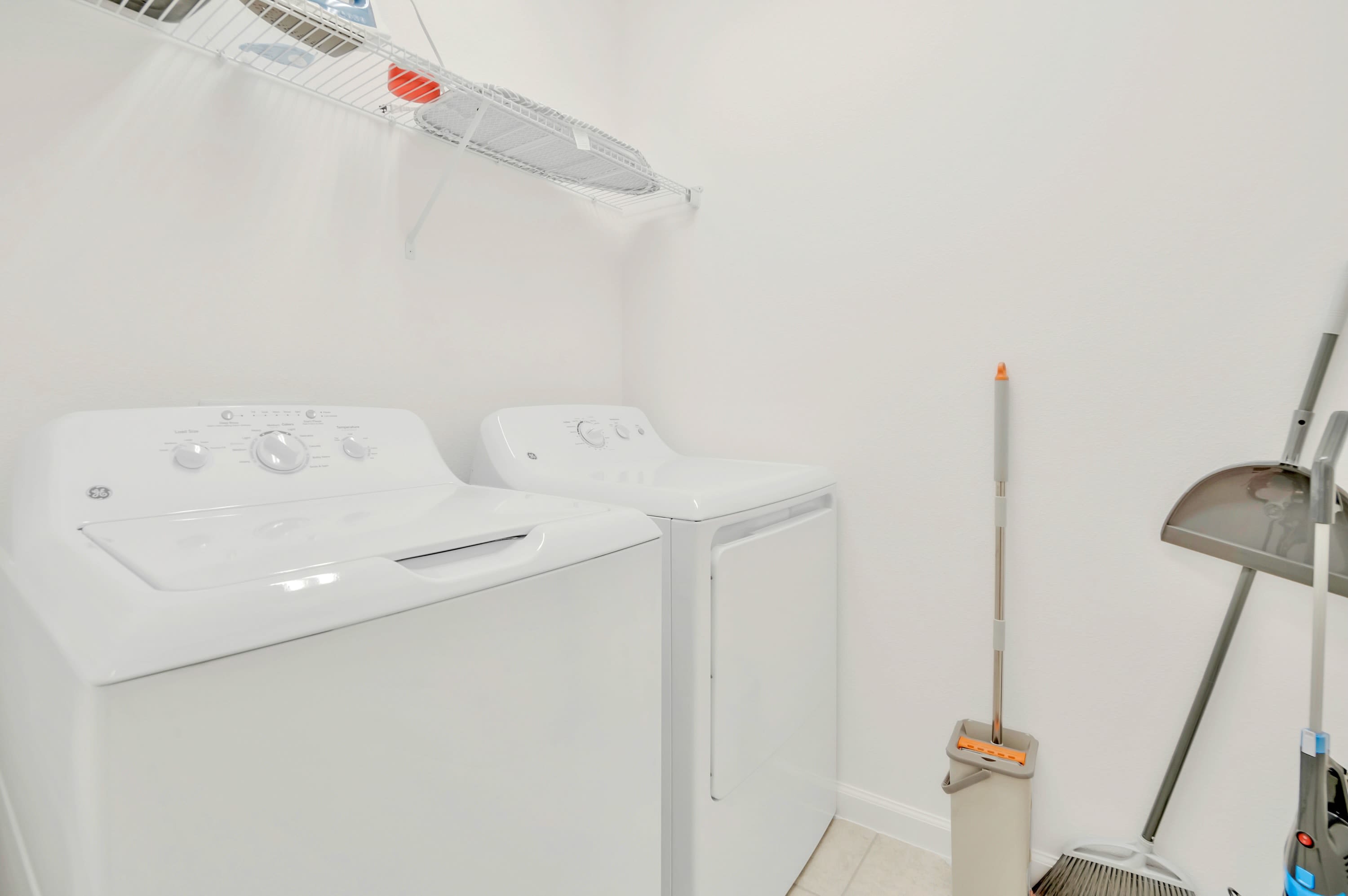 Convenient in-unit laundry area featuring a modern washer and dryer