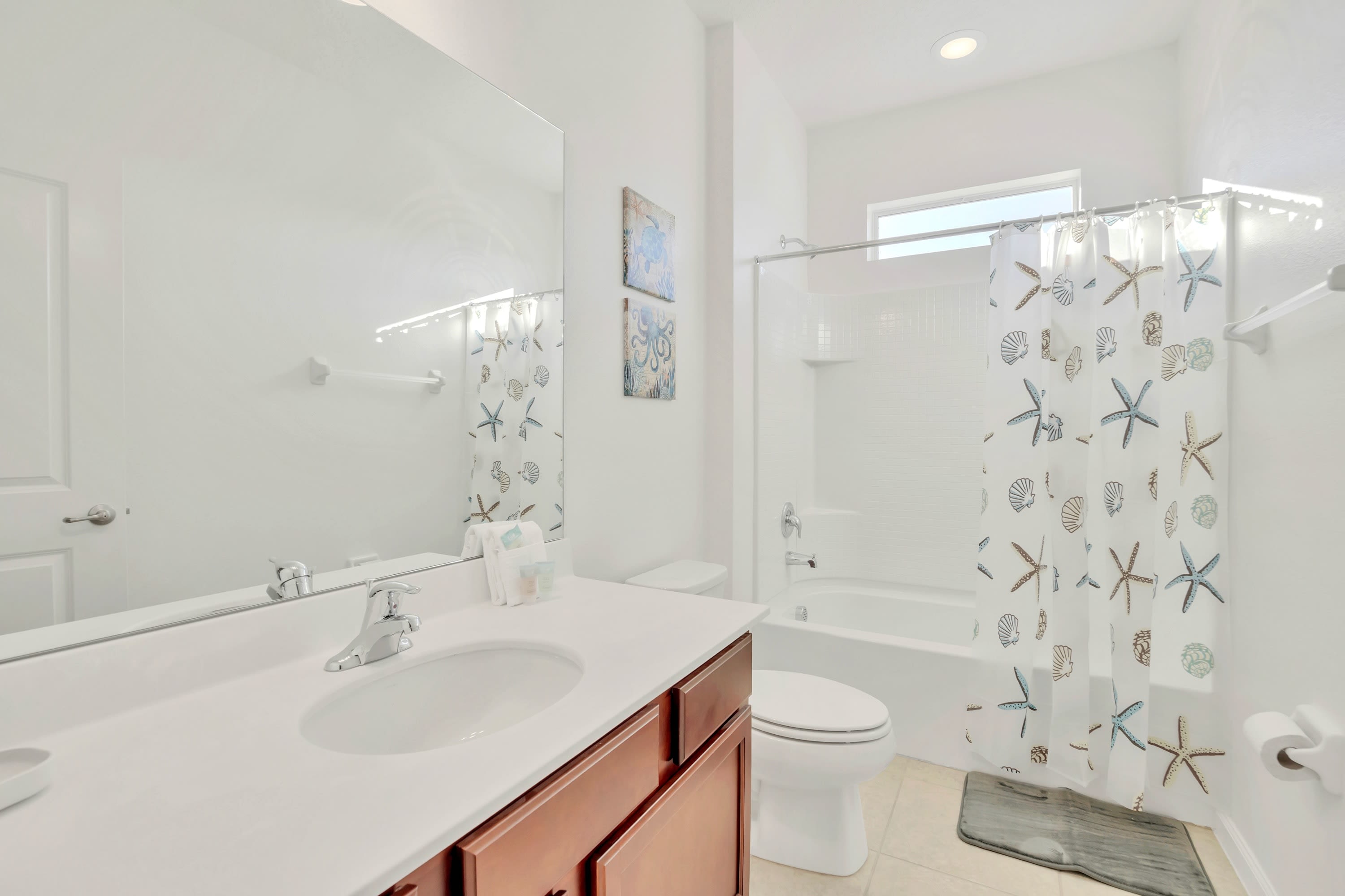 A clean bathroom layout complete with a full tub shower combination