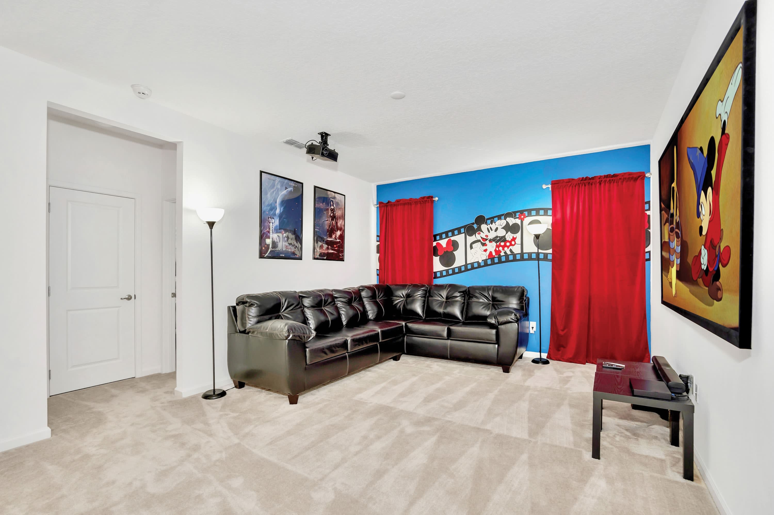Upper-level family room equipped with a wall-mounted TV and comfortable seating