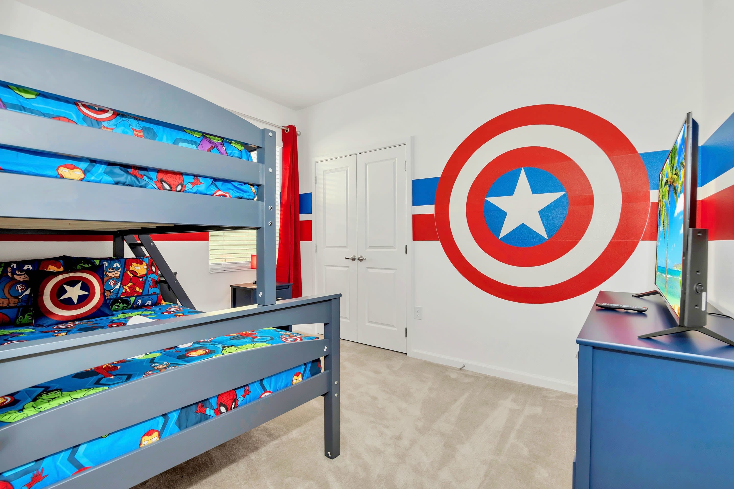 An action-packed superhero bunk bedroom with custom shield wall graphics
