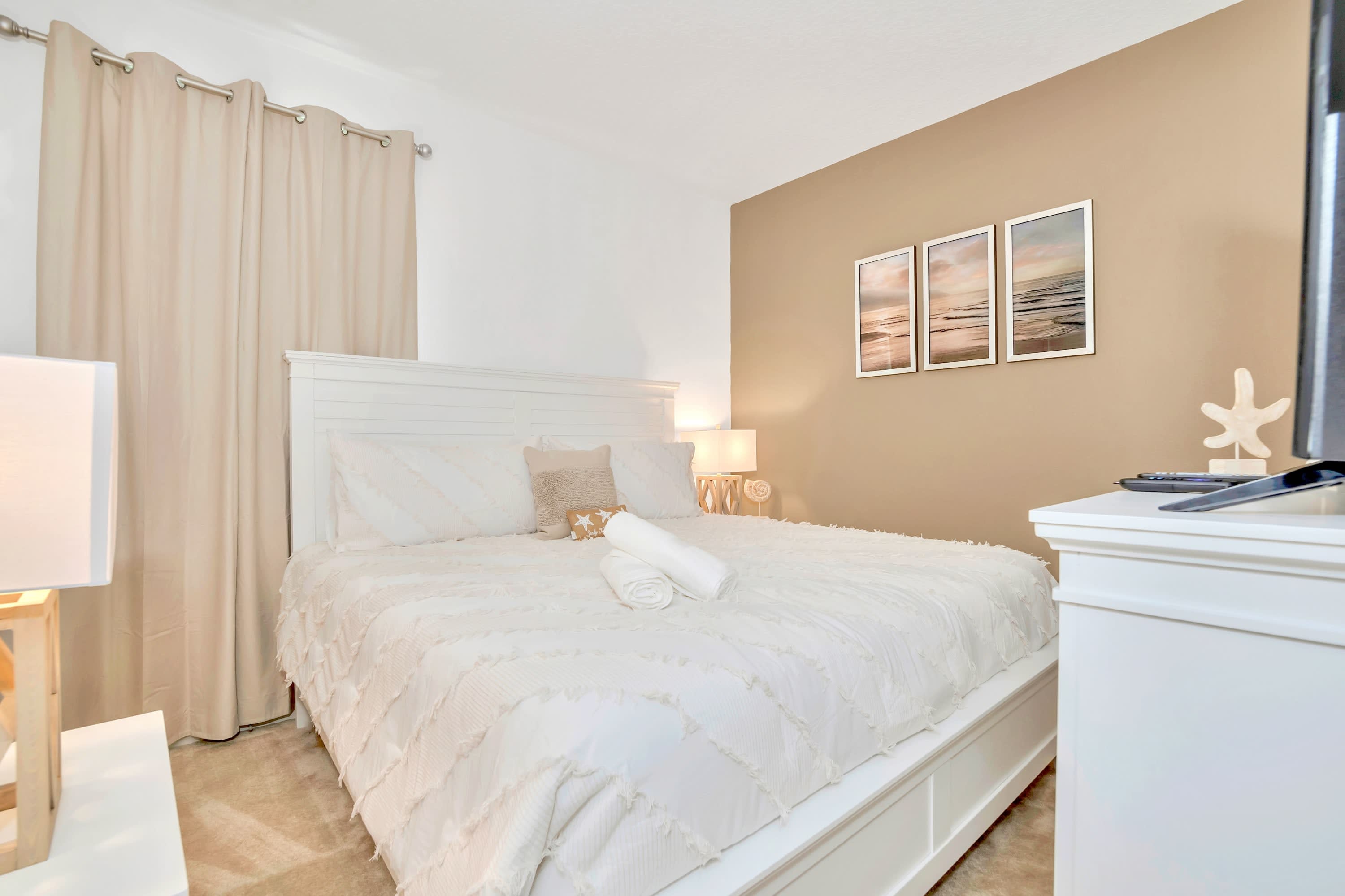 A peaceful bedroom retreat dressed in crisp white linens and neutral decor