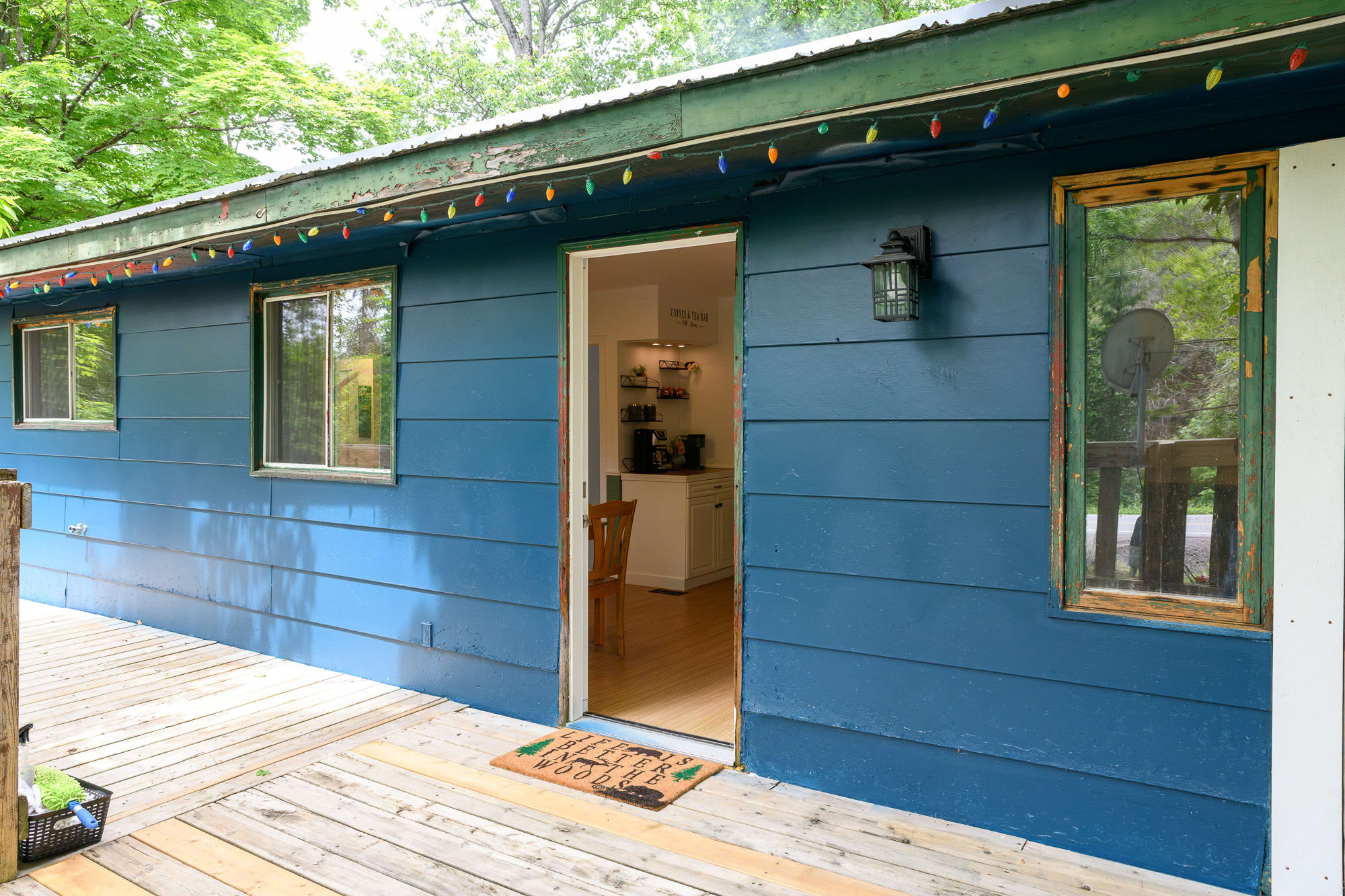Step Into The Warmth Of This Cabin Through Its Inviting Entryway Surrounded By Nature