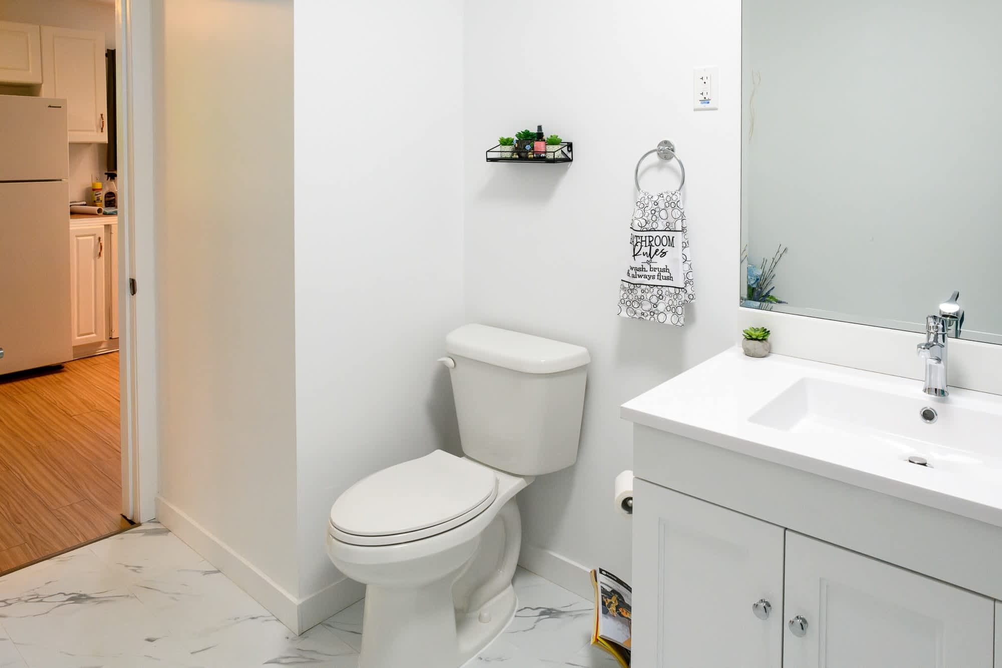 Bright And Modern Bathroom With Sleek White Fixtures And Subtle Accents