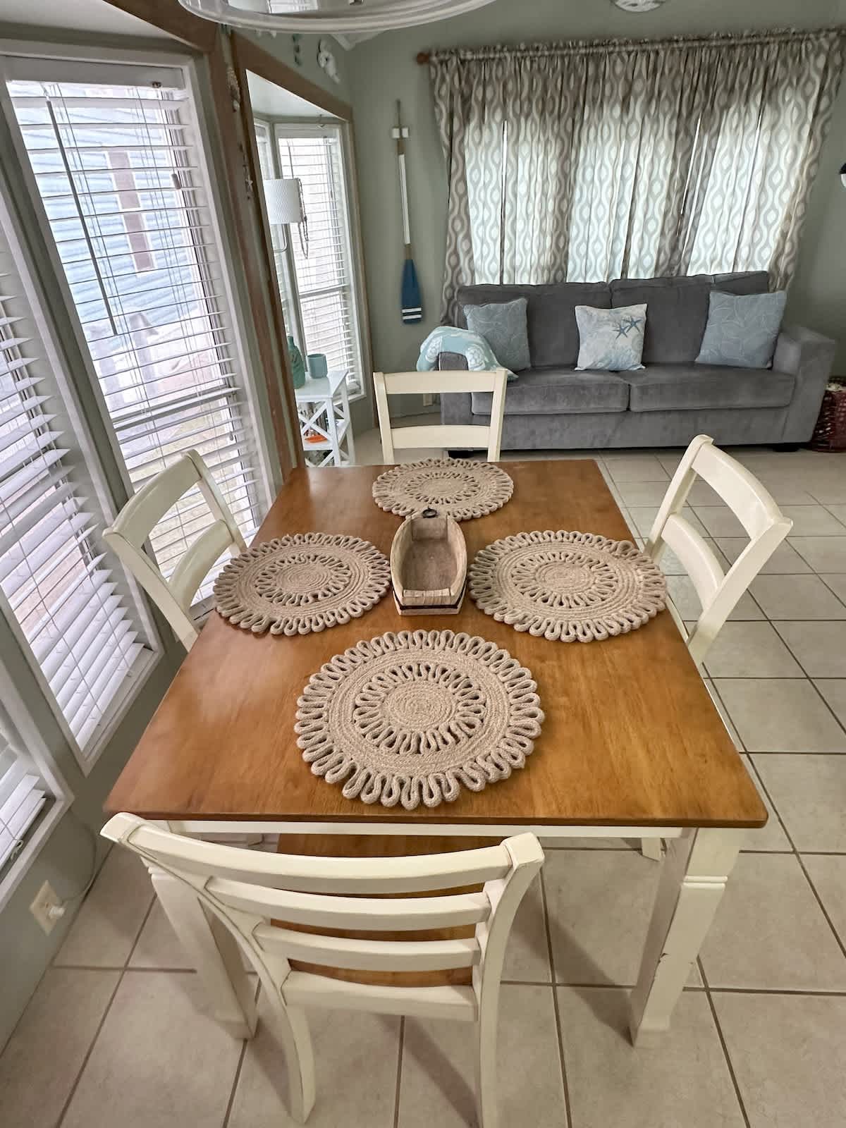 Charming dining nook for four, surrounded by windows for a bright mealtime experience.