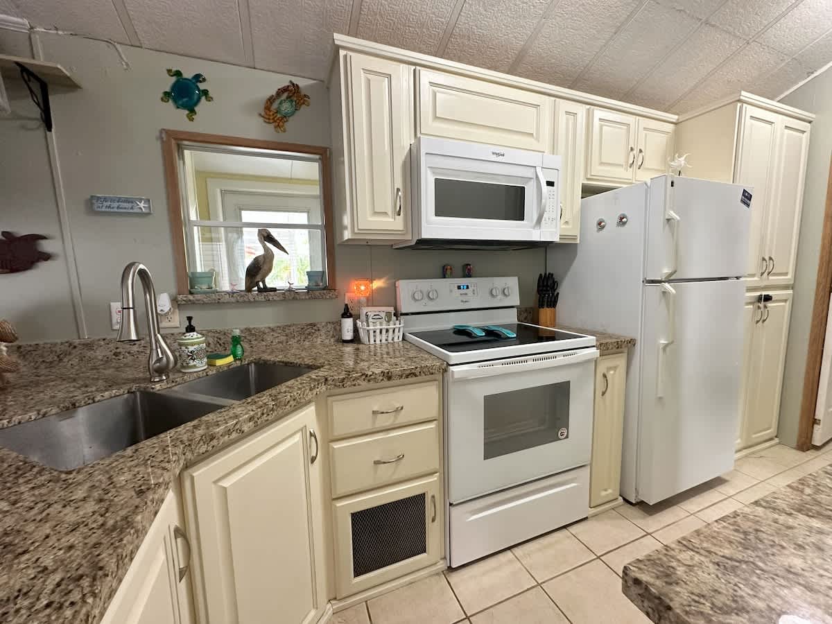 Fully equipped kitchen with appliances, granite countertops, and all your cooking essentials.