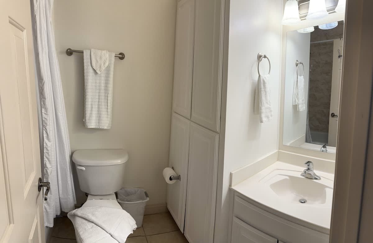 Full bathroom with a standing shower, stocked with fresh towels.