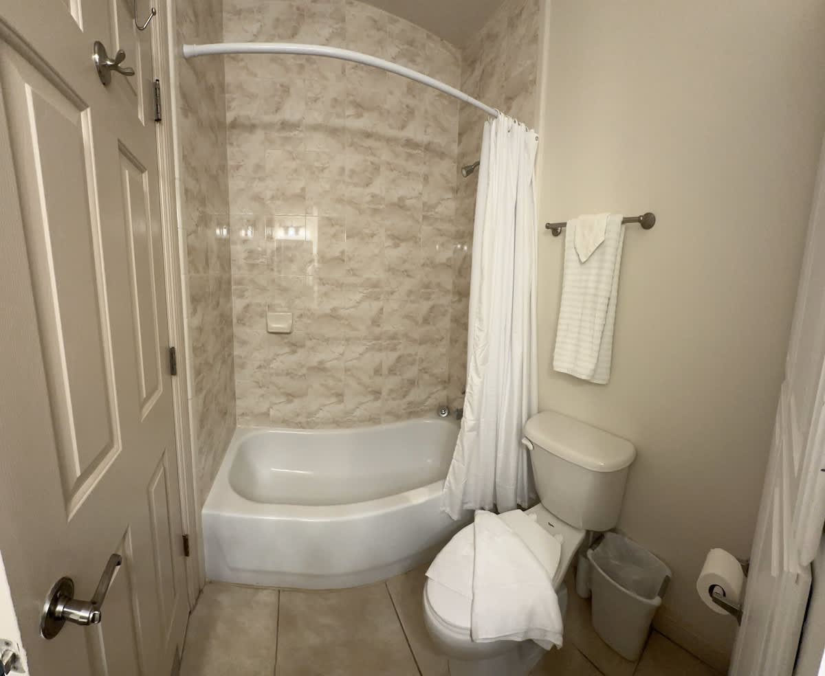 Full bathroom with a standing shower, stocked with fresh towels.