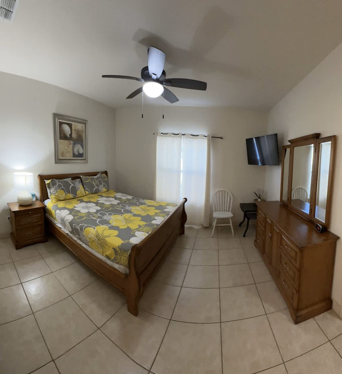 Primary King Bedroom: Rejuvenate on a king-sized bed, ceiling fan, and plenty of natural light — your private retreat for a good night’s sleep.