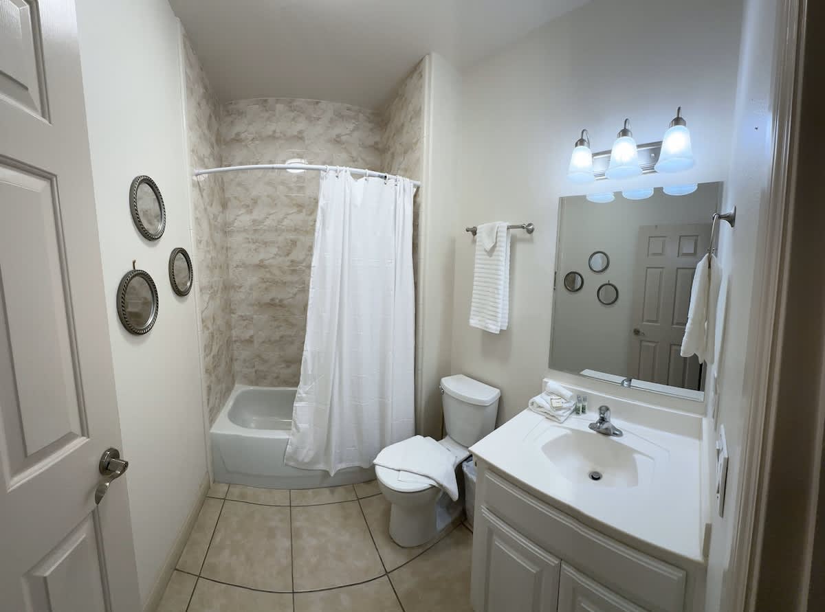 Full bathroom with a standing shower, stocked with fresh towels.