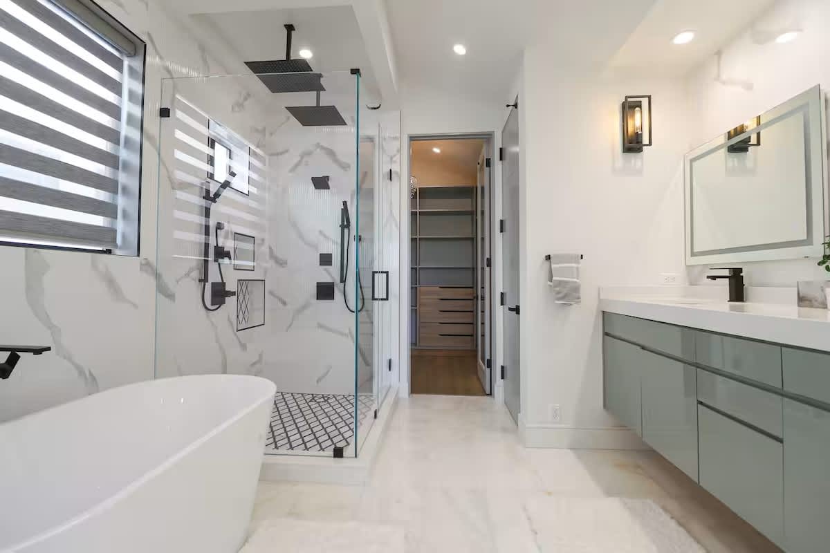 Master Bathroom with Tub and Separate Large Shower with multiple shower heads. Bathroom includes a bidet and spacious walkin Closet.