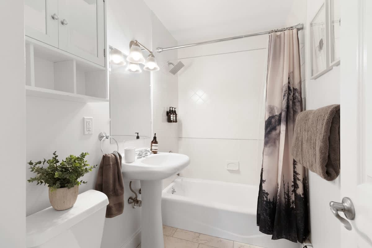 First bathroom with a tub, fully stocked with essentials
