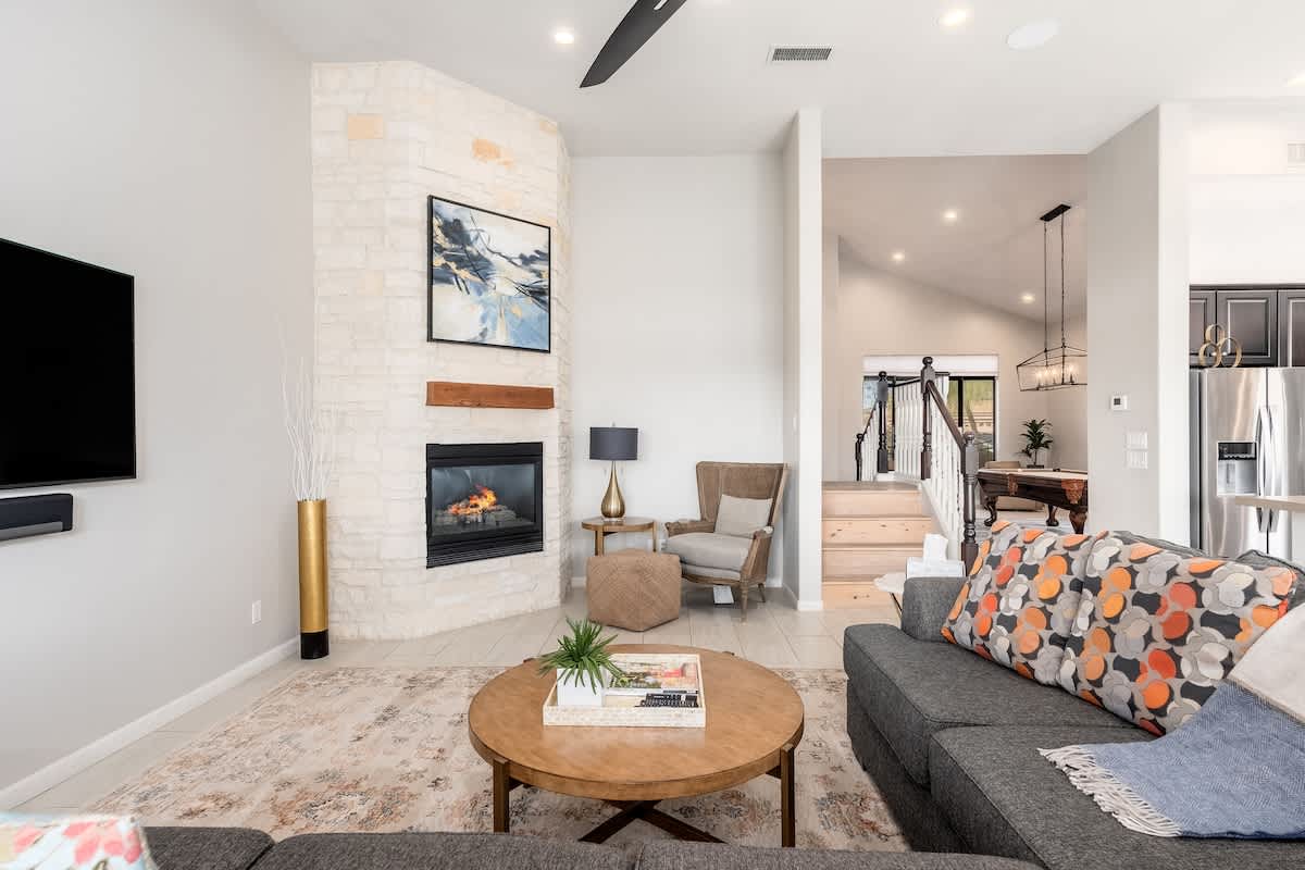 Unwind in your bright, open living space featuring a cozy fireplace, modern furnishings, and elegant touches that make every moment feel like home.