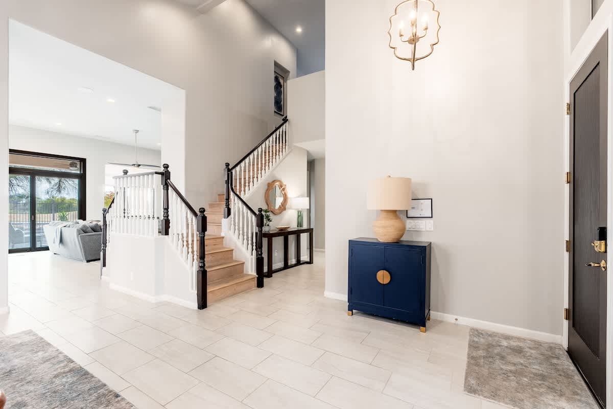 Step into a bright, open foyer where natural light flows through elegant spaces, setting the tone for your stay in this thoughtfully designed home.