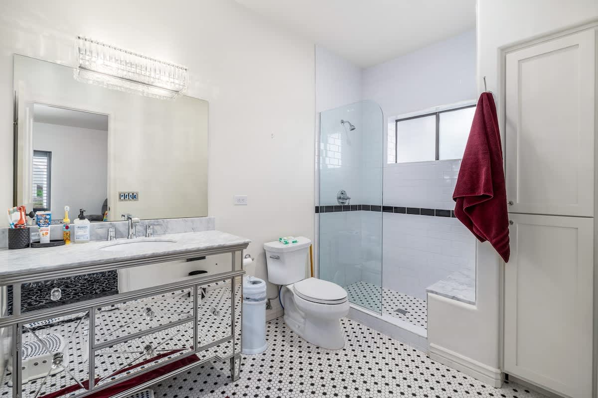 Step into your elegant private bathroom with classic tilework, a walk-in glass shower, and gleaming fixtures—your personal spa awaits after each day of adventure.