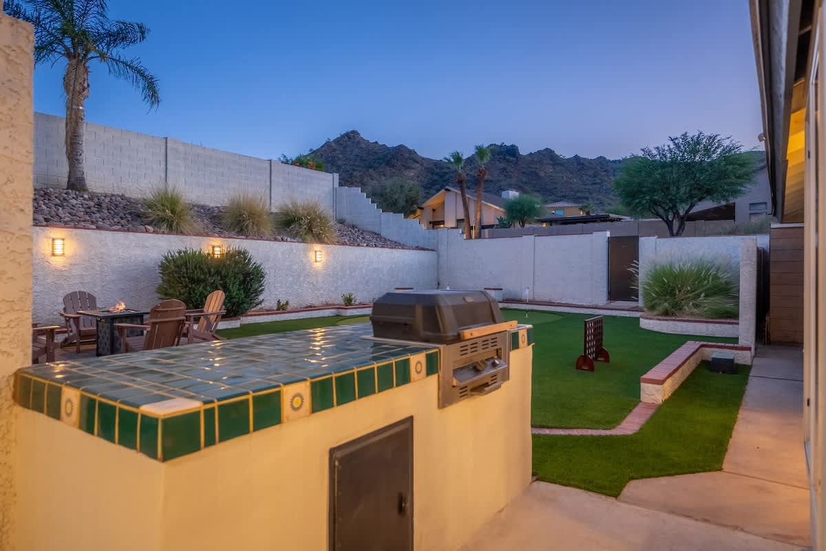 Step onto your private patio where the Arizona mountains create a stunning backdrop. Fire up the built-in grill as the evening lights illuminate your lush lawn and cozy outdoor seating area.