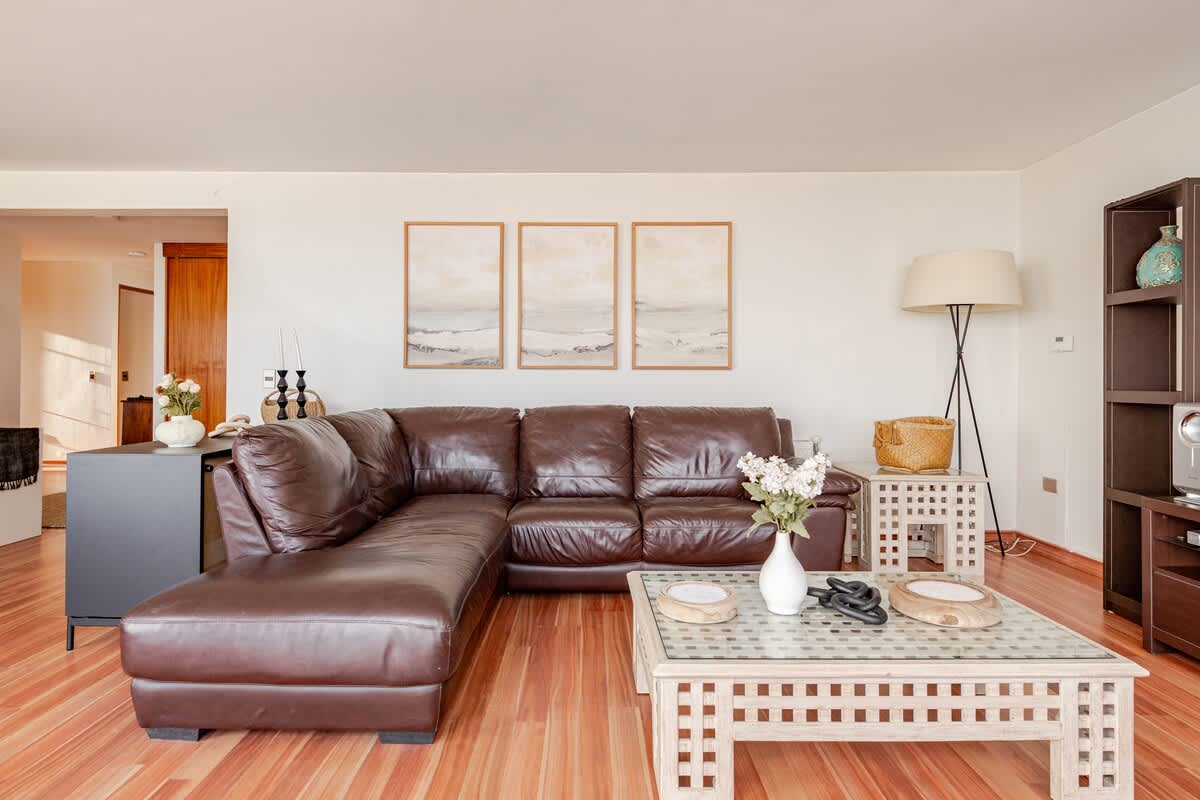 Relax in this cozy living room with a plush leather sofa and stylish decor, perfect for unwinding after a day of exploring.