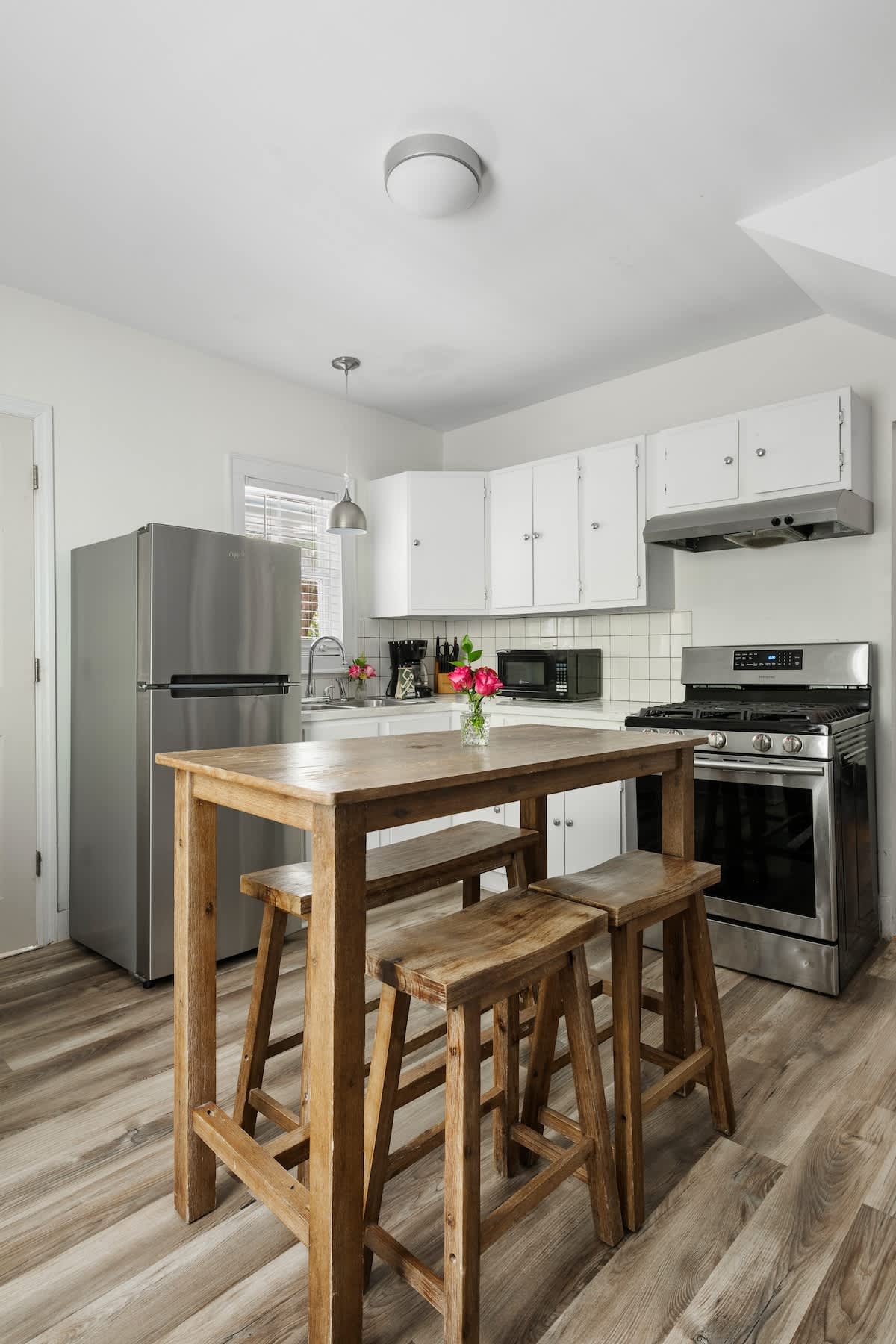 Kitchen with seating for 4 at a bar top table. 