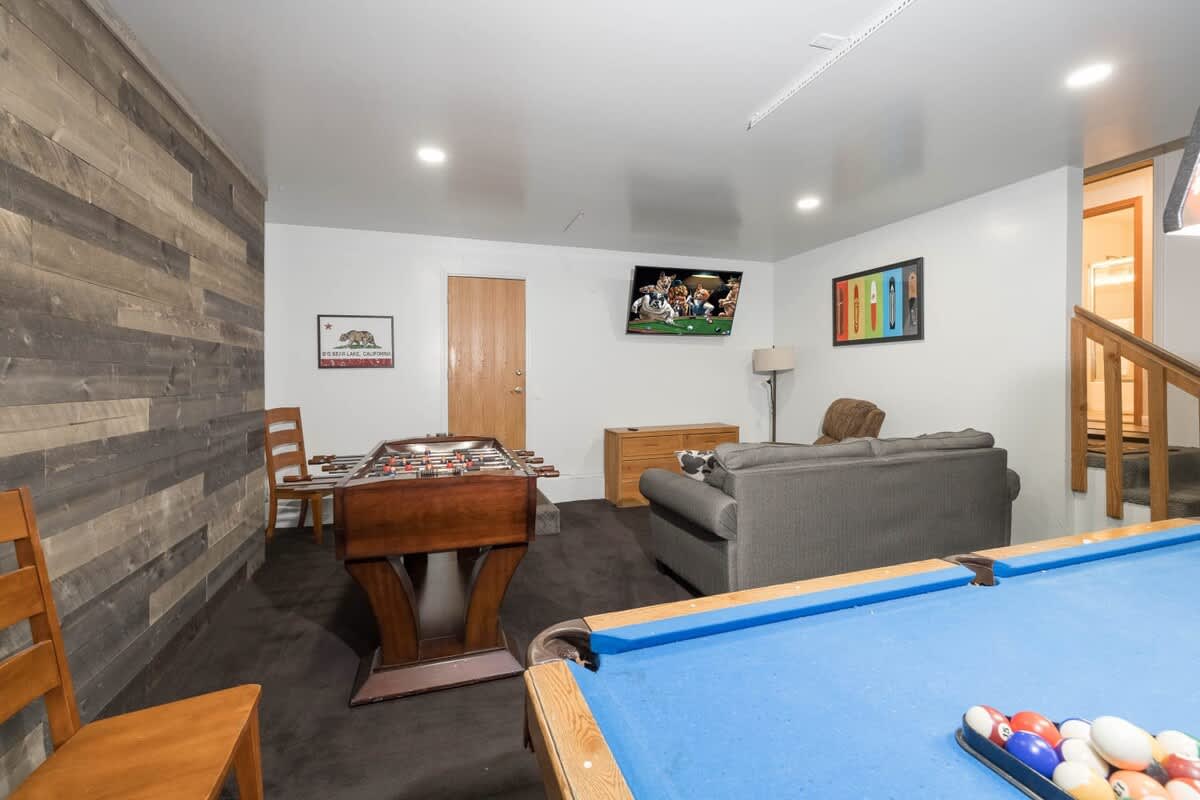 Game room with pool table, foosball and plenty of seating.