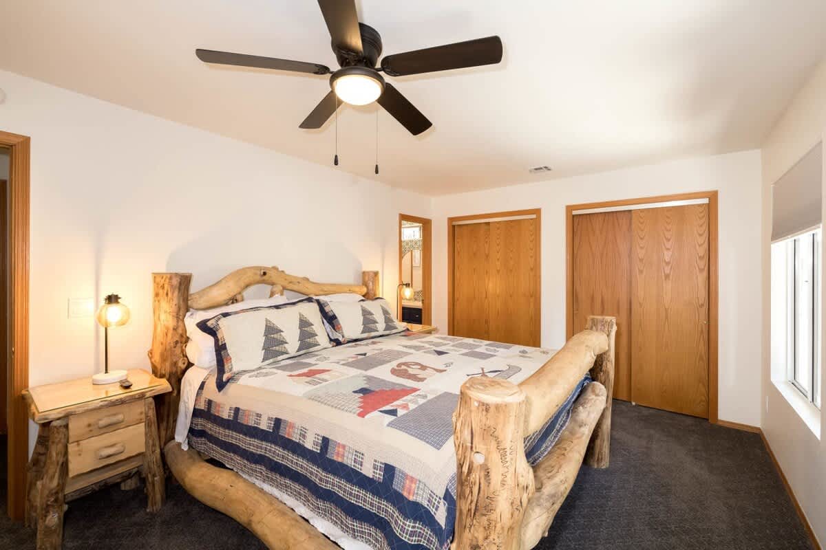 Comfortable Master Bedroom with California King Log Bed & Private Bathroom.