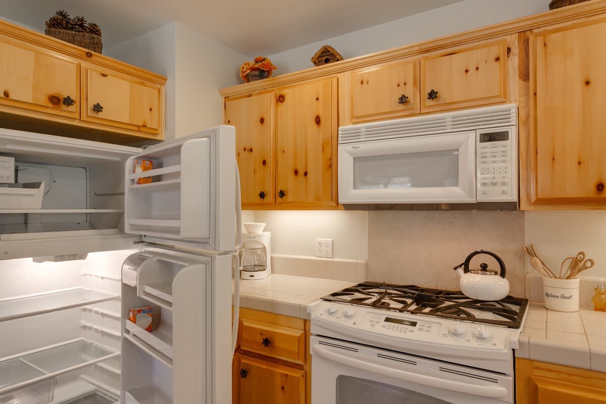 Kitchen with gas range and microwave
