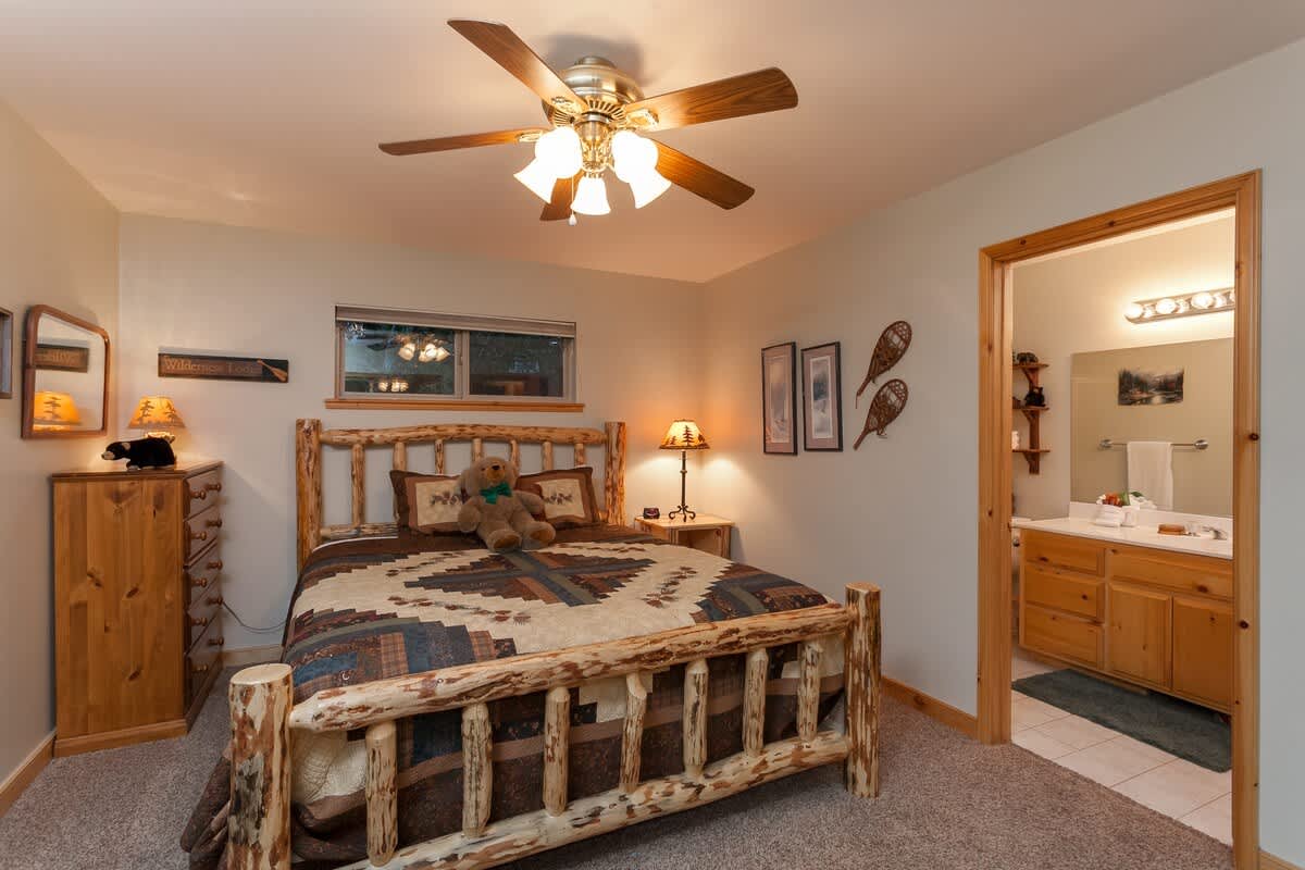 Primary bedroom with King log bed and private bath