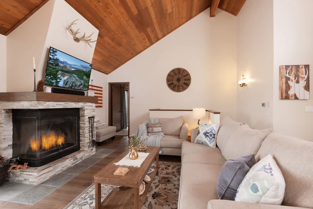 Living room with wood-burning fireplace and Smart TV