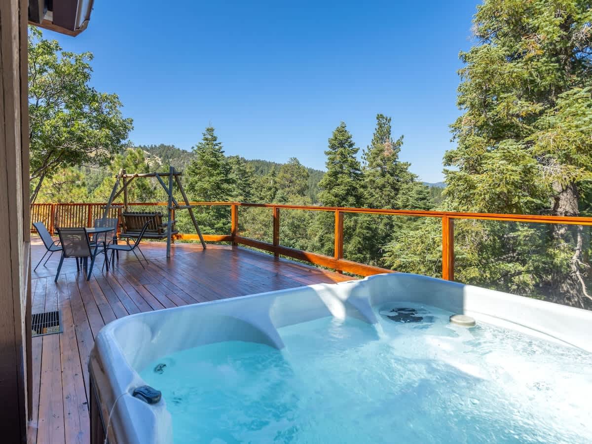 Private hot tub on the deck with forest and mountain views