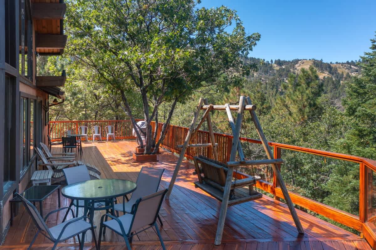 Deck with swing, dining table and lounge chairs