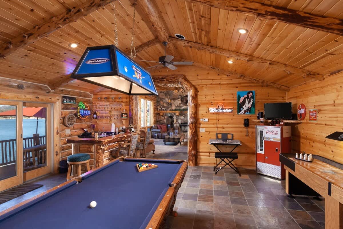 Game room with pool table, shuffleboard, poker table and bar