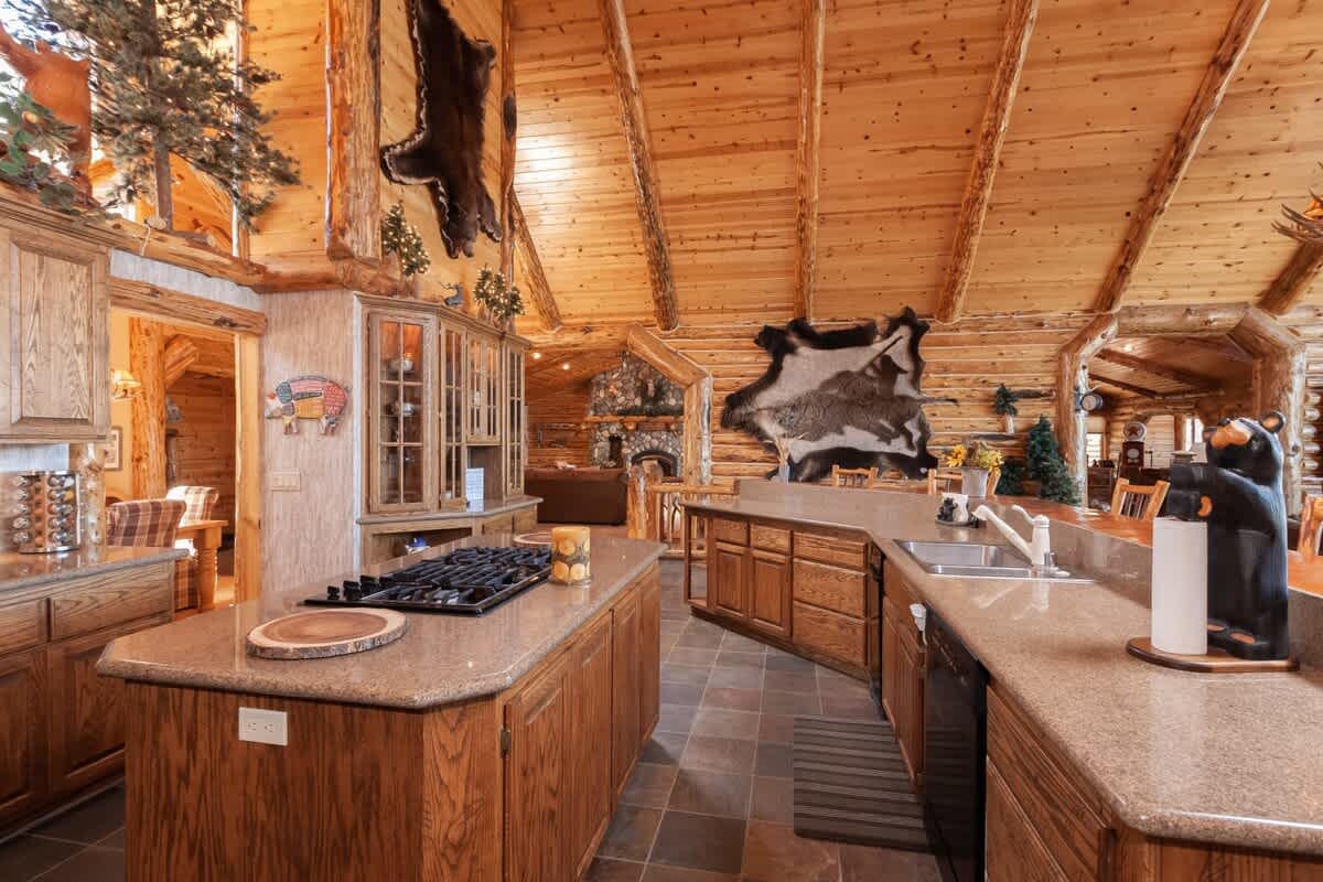 Kitchen opens to both living areas with lake views