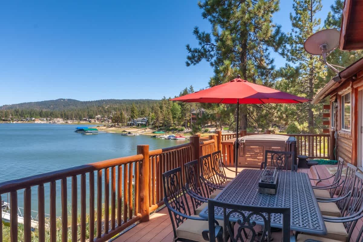 Deck dining with lake views and propane fire table