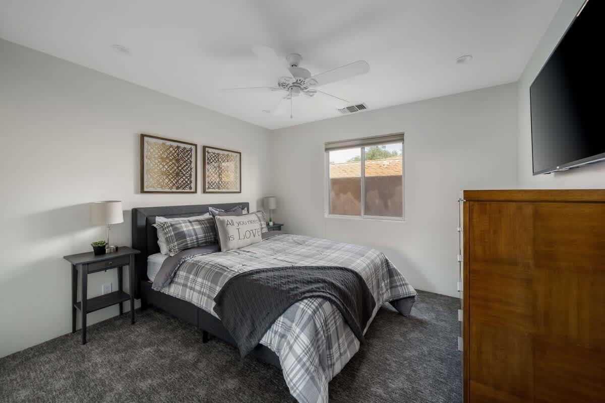 2nd bedroom with cozy plaid bedding and plenty of storage.