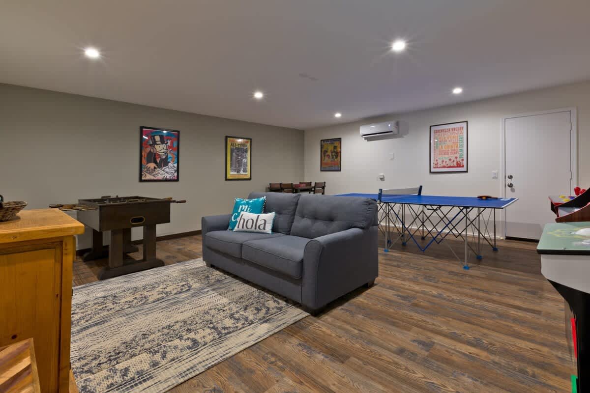 Game room lounge with sofa and foosball.