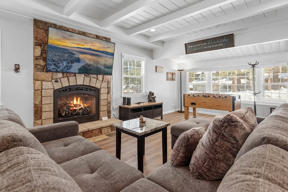 Living room with stone gas fireplace and smart TV