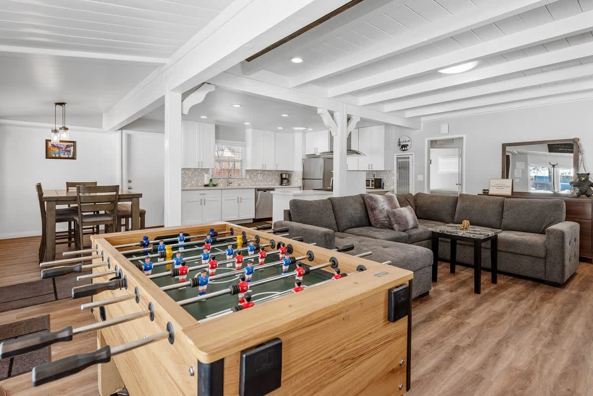 Open living area with foosball table and sectional