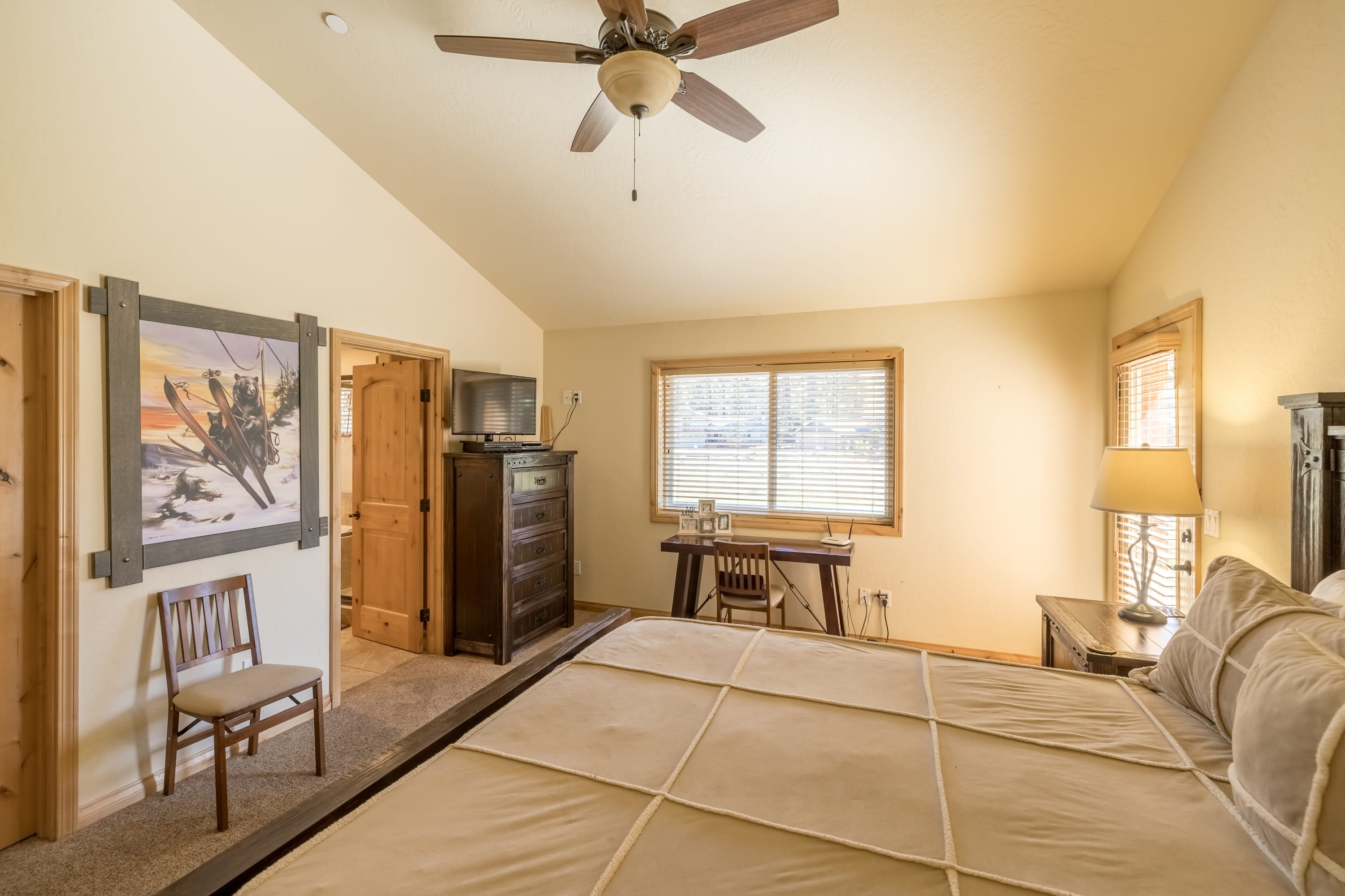 Primary bedroom with desk for remote work