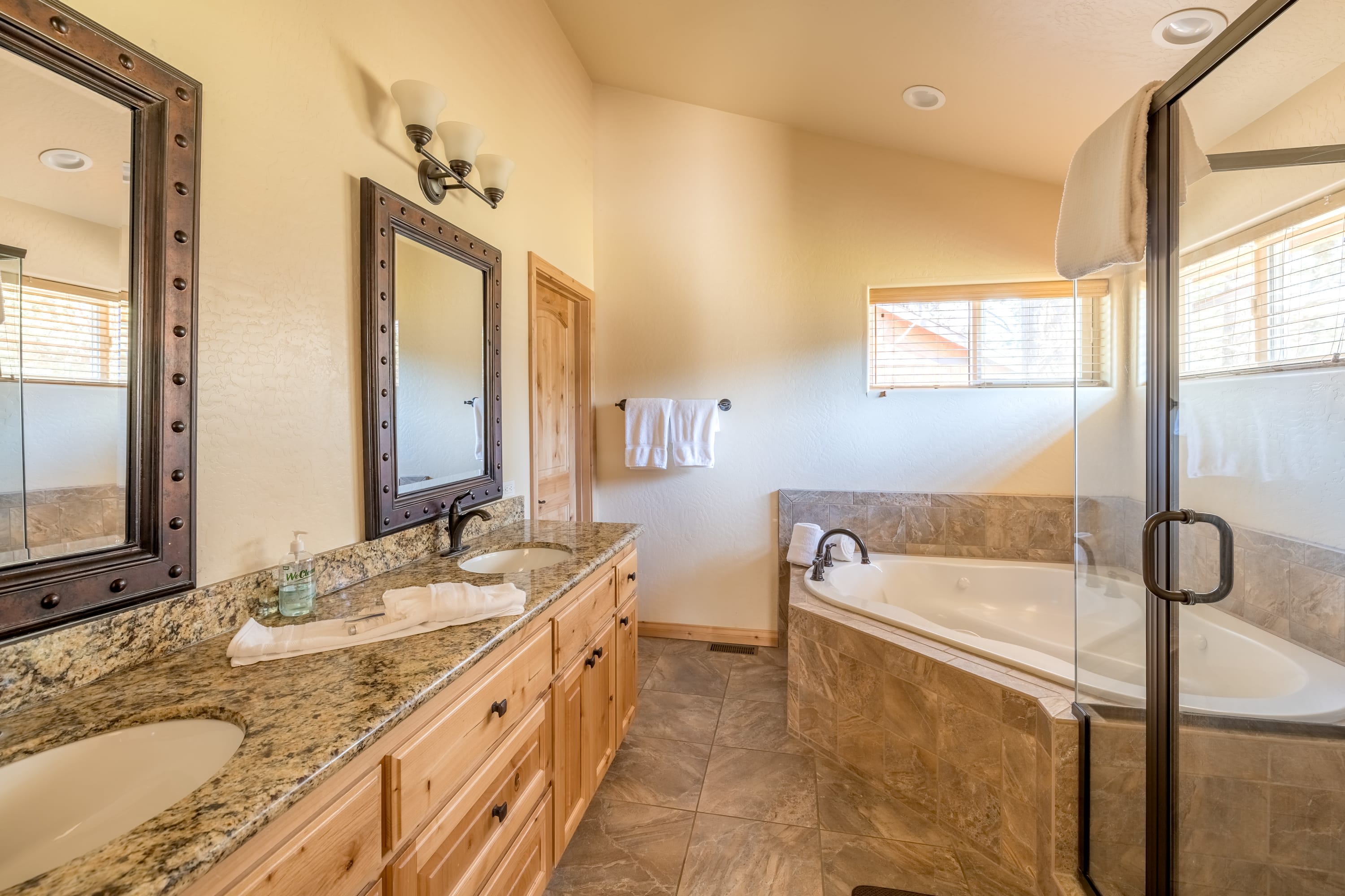 Primary bathroom with jetted tub and walk-in glass shower