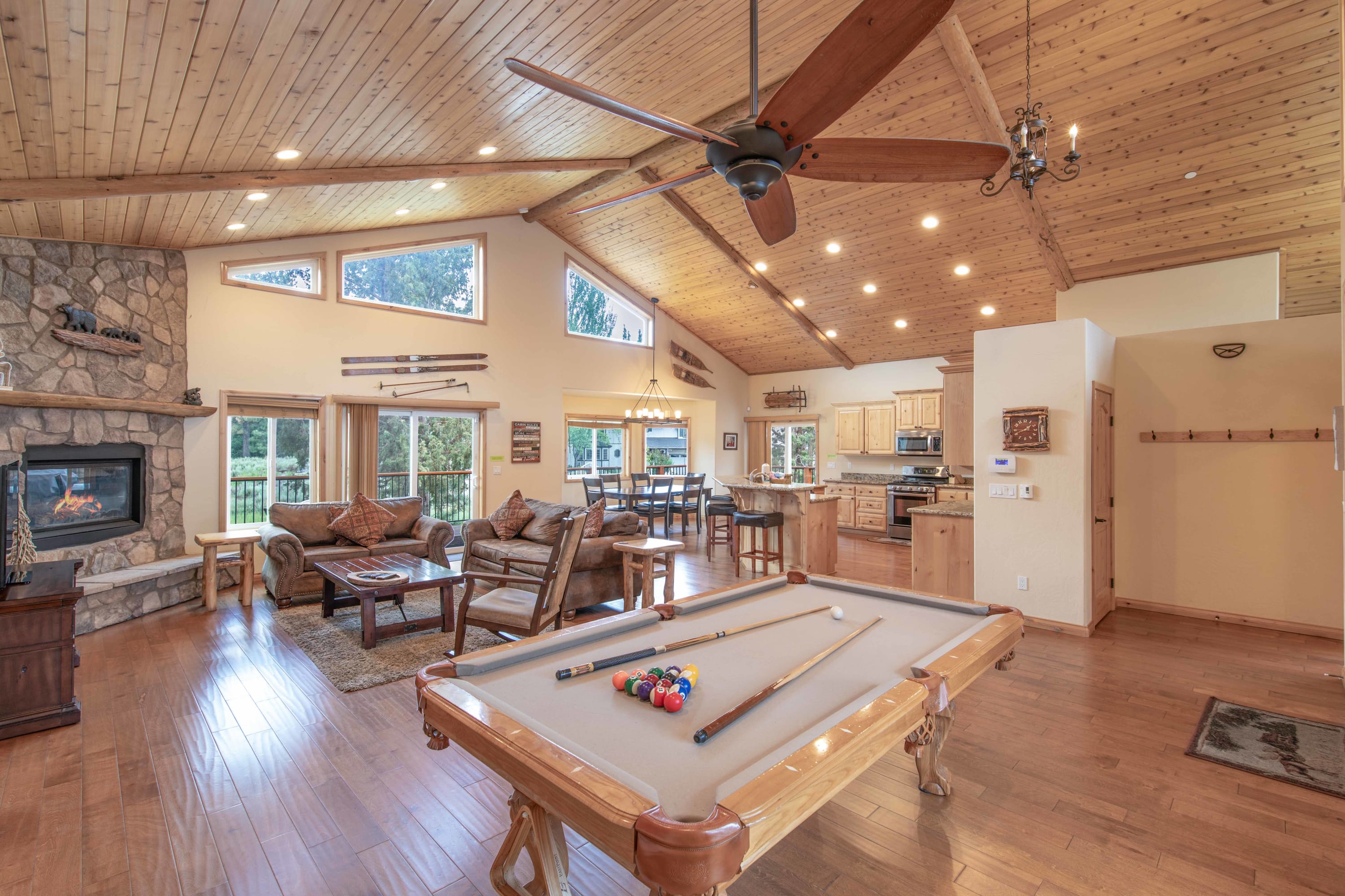 Open living area with slate pool table and wood-beam ceilings